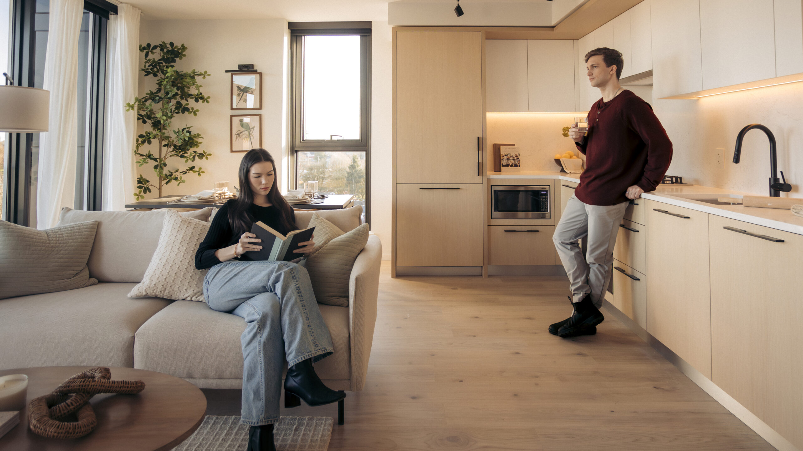 Modern open-concept living and kitchen space at Frame with natural light, contemporary finishes, and comfortable everyday living