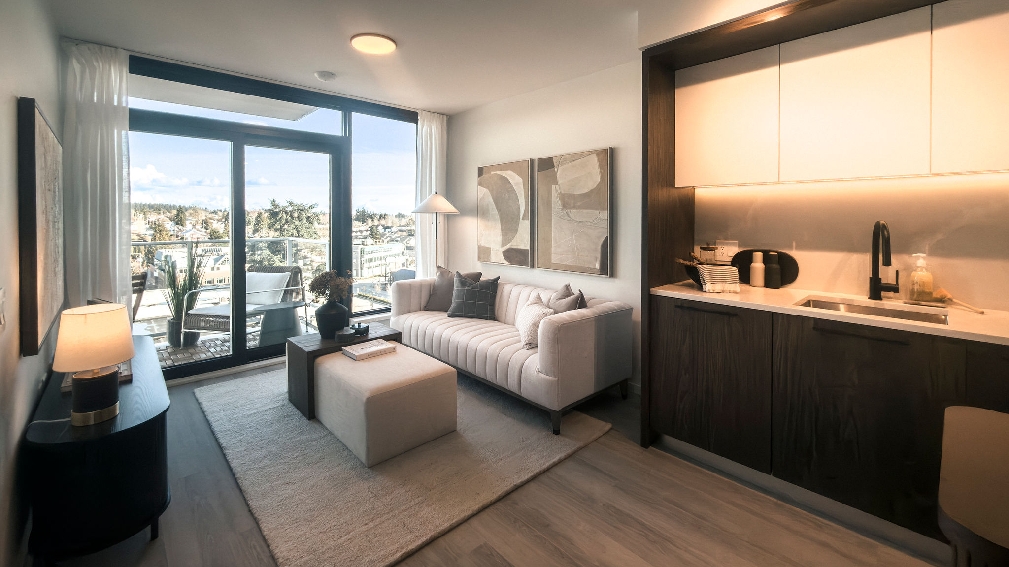 Modern studio condo with kitchenette, large window, and city view in East Vancouver