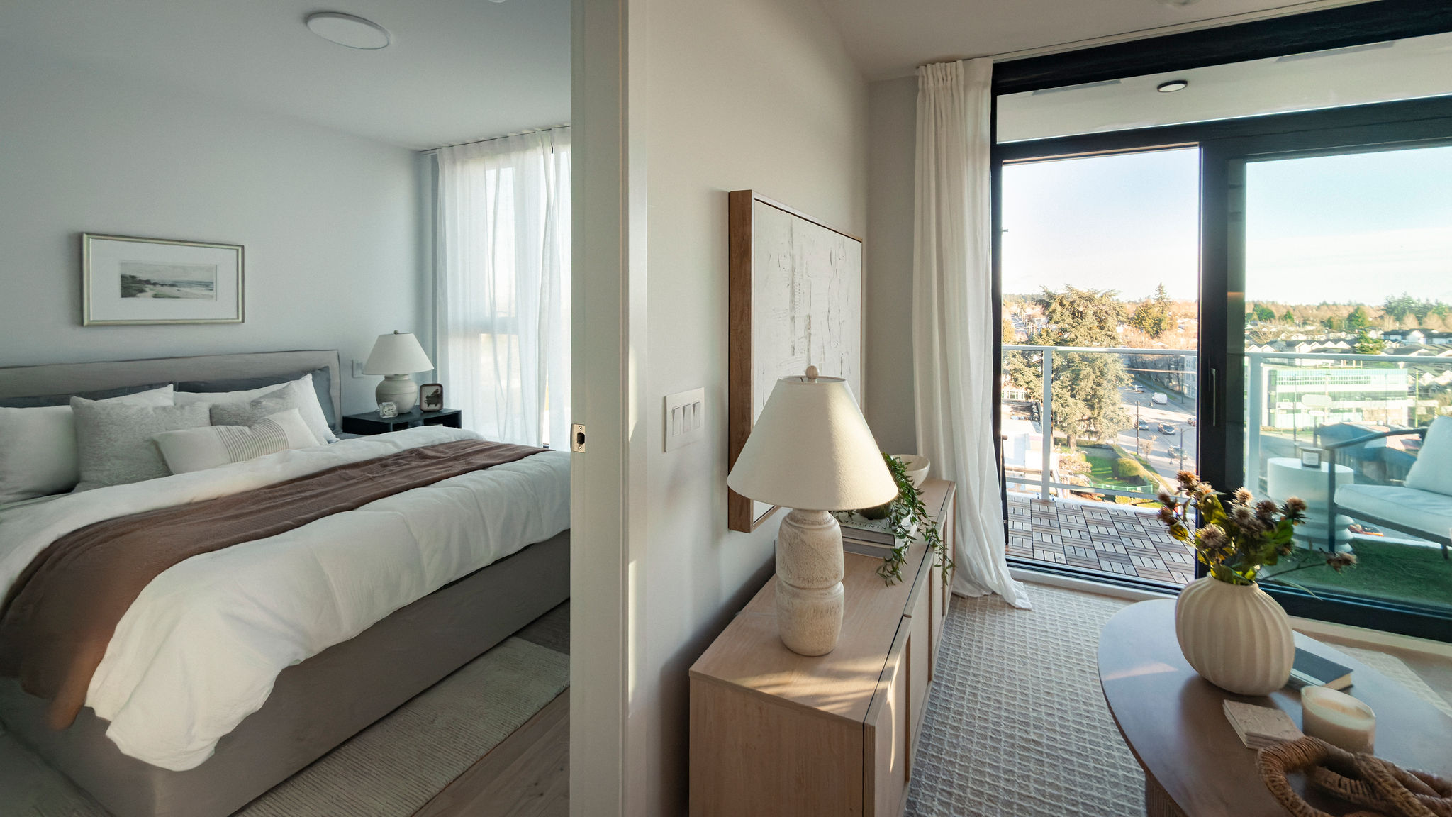 Bedroom with large window and balcony access, natural light, and city views in East Vancouver condo